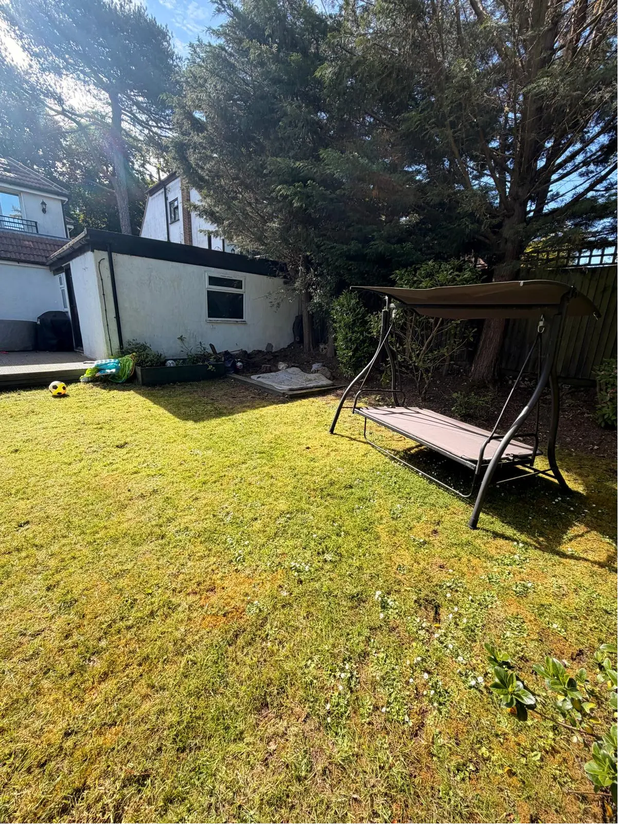 The rear garden at Portnalls Road with patchy lawn before the work started