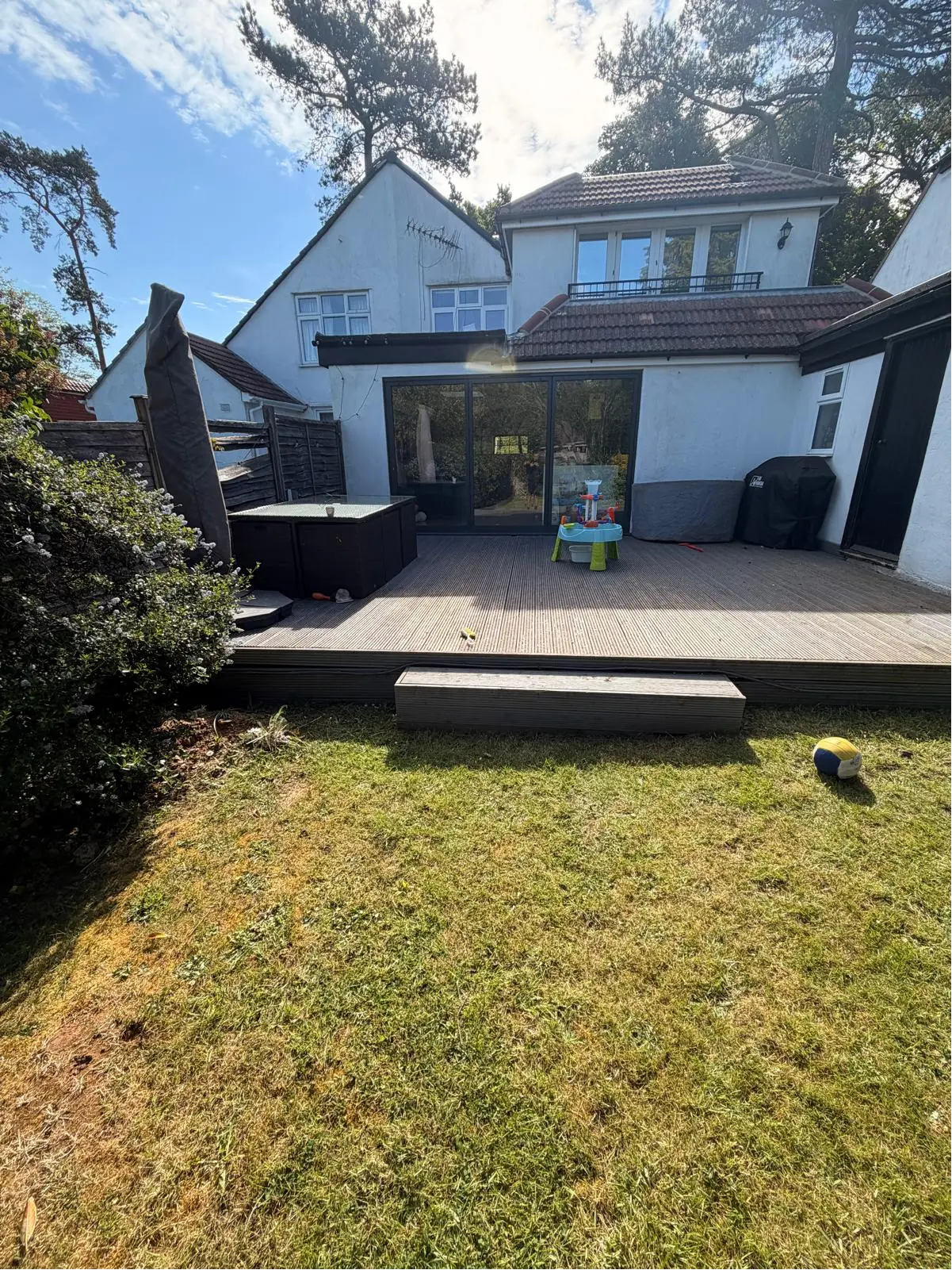 The back of the house at Portnalls Road with old grey decking before the work started